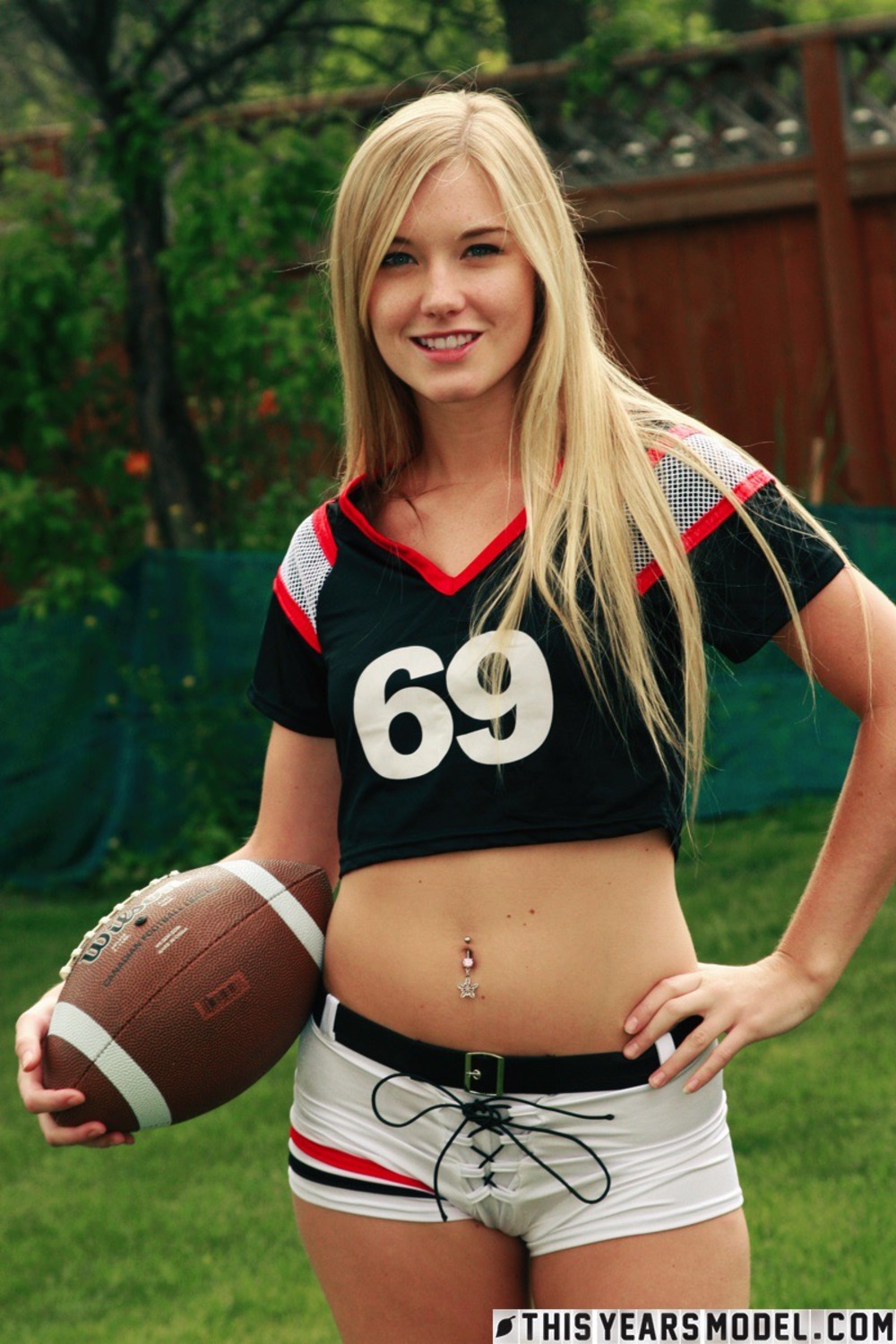 Cute Blonde Football Fan Girl Jewel Strips In The Garden 00