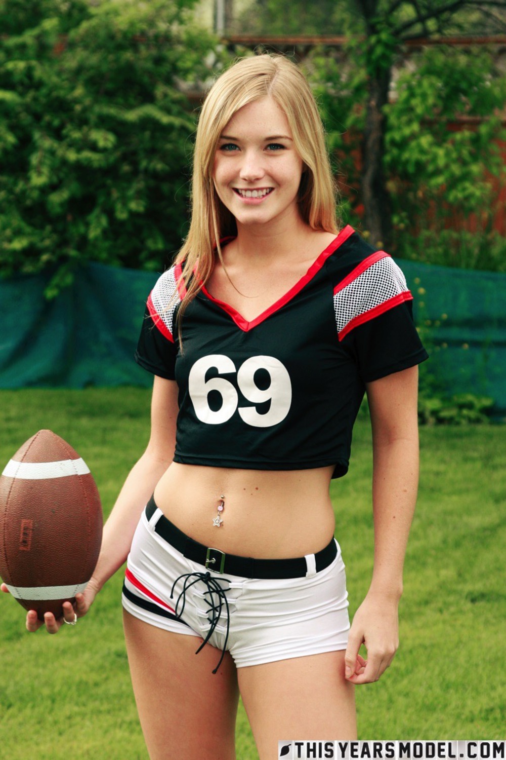 Cute Blonde Football Fan Girl Jewel Strips In The Garden 02