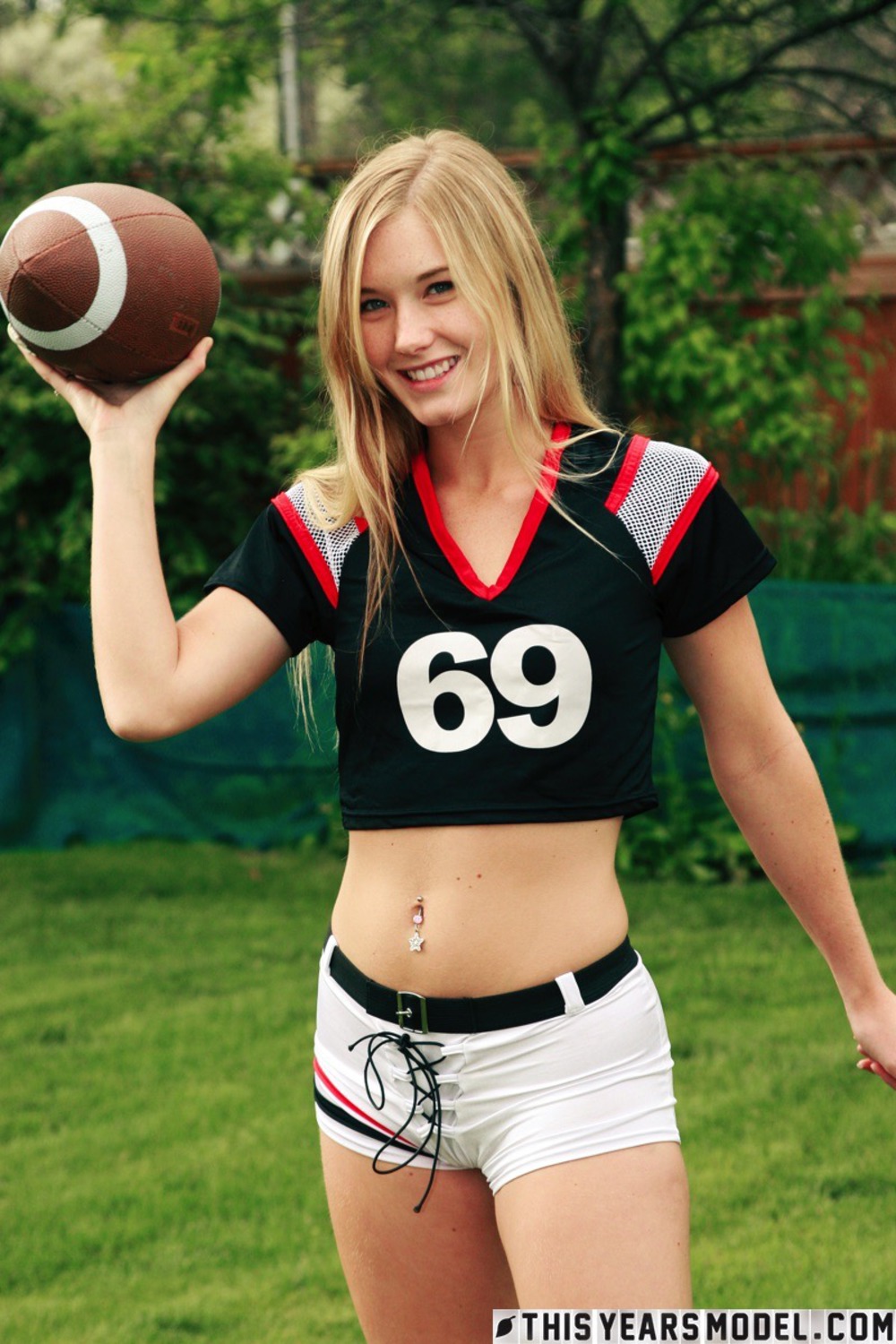 Cute Blonde Football Fan Girl Jewel Strips In The Garden 05