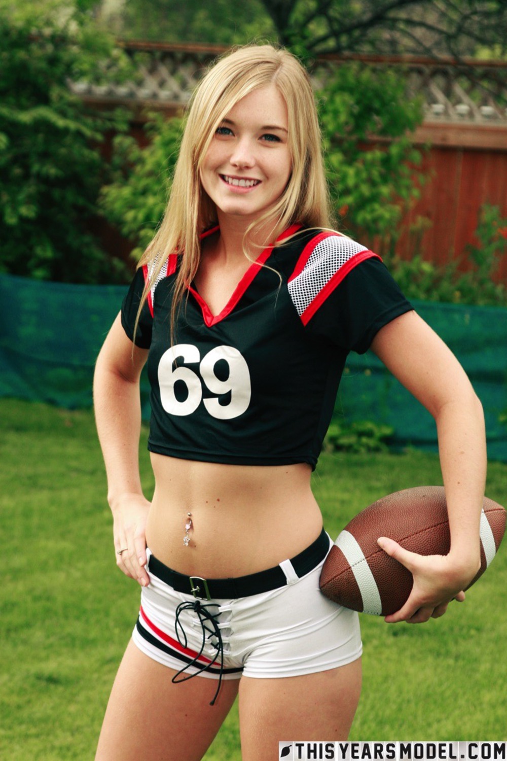 Cute Blonde Football Fan Girl Jewel Strips In The Garden 06