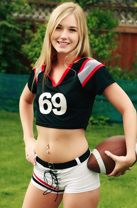 Cute Blonde Football Fan Girl Jewel Strips In The Garden
